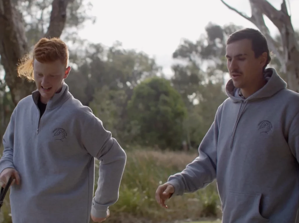 Teen and counsellor having a serious conversation while standing outside Caption: Shake Counselling fosters open communication and emotional development for Geelong youth.