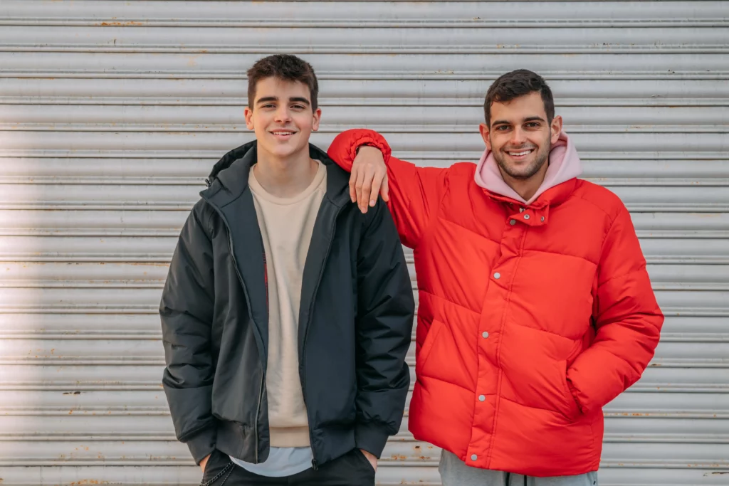 Two smiling teenage boys, arm in arm, depicting the power of supportive relationships through Geelong youth counselling