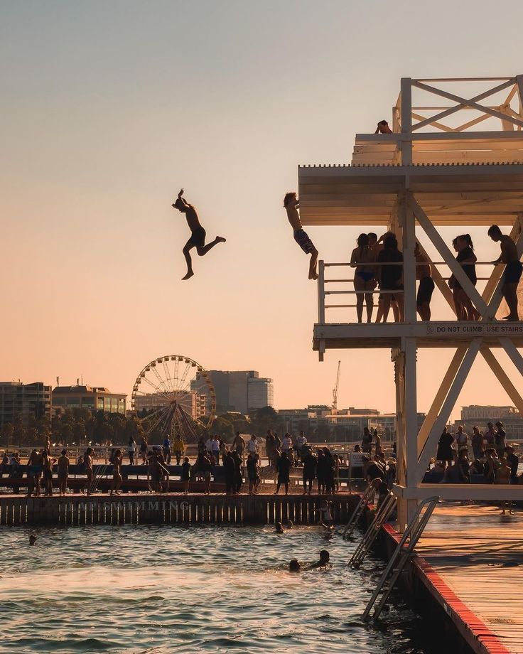 Young person taking a confident leap from a diving platform at sunset, symbolizing emotional breakthroughs in movement-based therapy