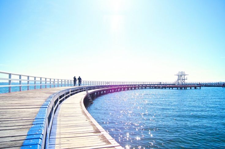 Serene waterfront view in Geelong with calm blue water, tree-lined banks, and outdoor recreational areas perfect for therapeutic activities